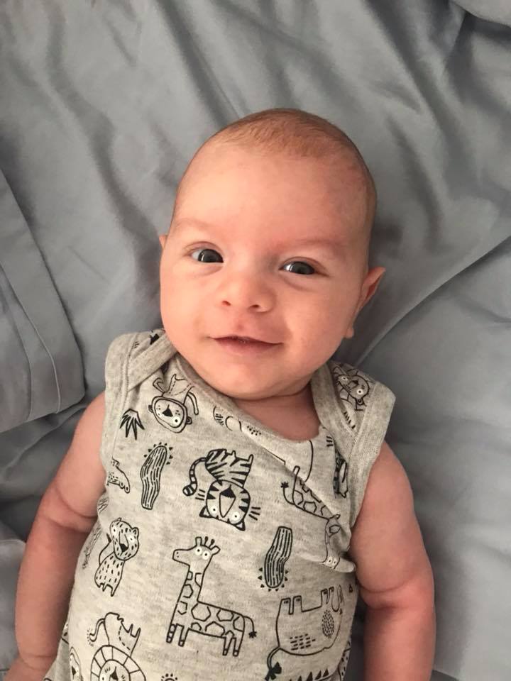 baby smiling on blue background